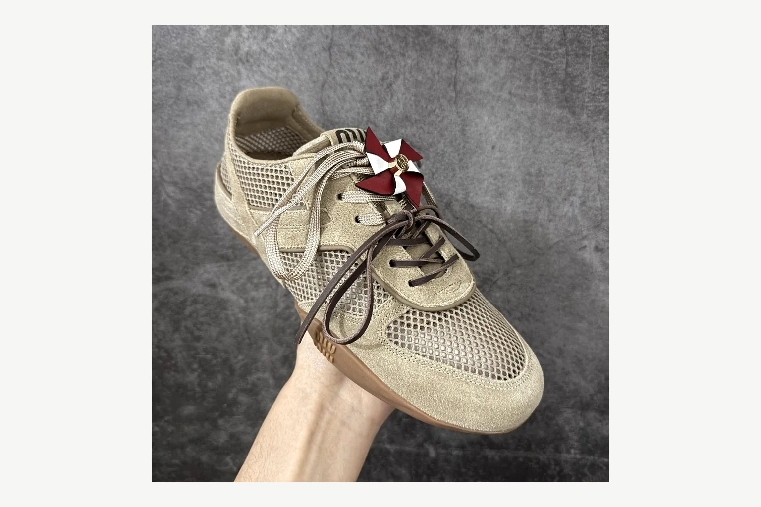Miu Miu Beige Logo Sneaker comparison signal photo with beige logo low-top with mixed-material upper and low-profile shape