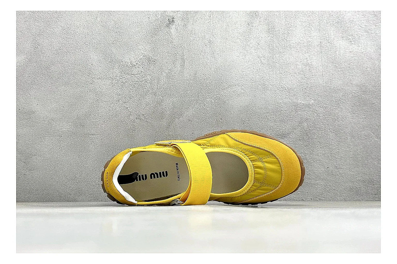 Miu Miu Tyre Yellow Mary Jane comparison photo showing yellow Mary Jane upper, strap closure, rugged Tyre outsole, and playful low-profile shape