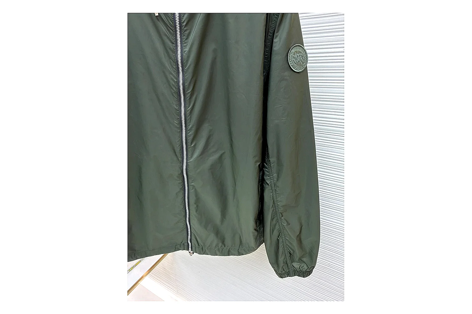 Moncler Nylon Hooded Jacket Olive Jacket comparison signal photo with olive nylon hooded jacket with nylon texture, hood structure, zipper line, sleeve cuffs, and light shell shape