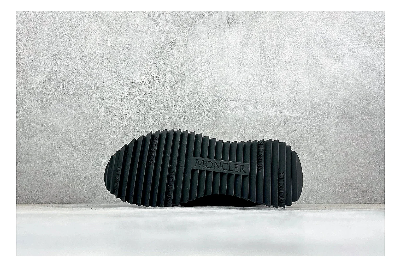 Moncler Pacey Black White comparison image with black upper, white rugged outsole, low padded collar, and outdoor-leaning tread profile thumbnail 4