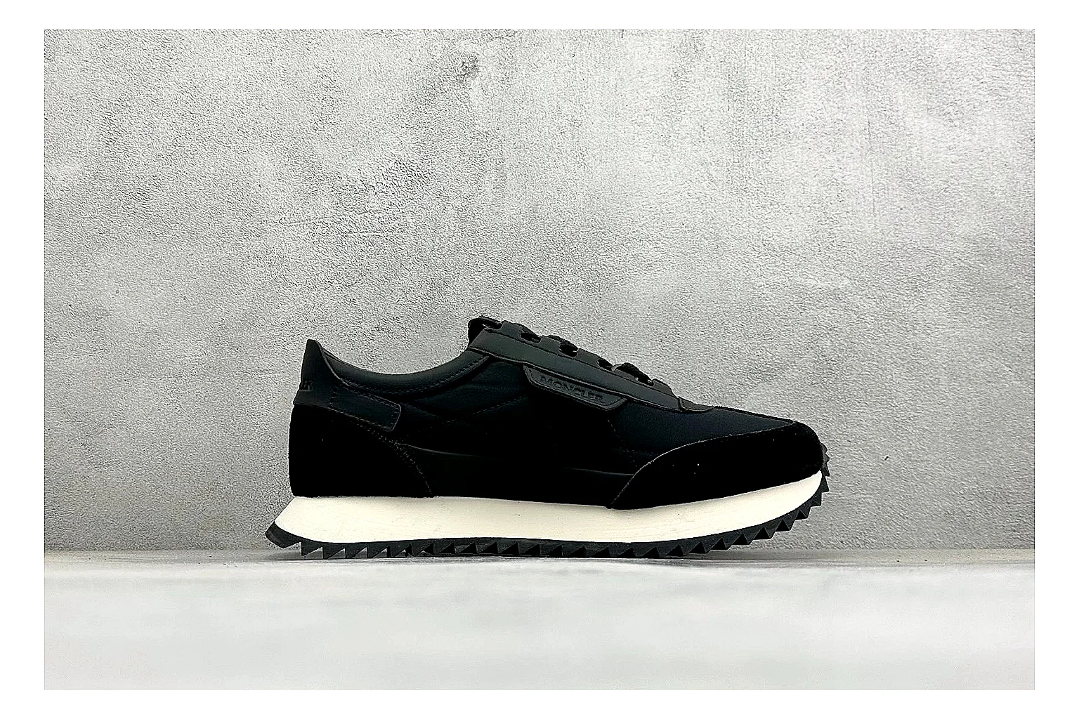 Moncler Pacey Black White comparison image with black upper, white rugged outsole, low padded collar, and outdoor-leaning tread profile thumbnail 6