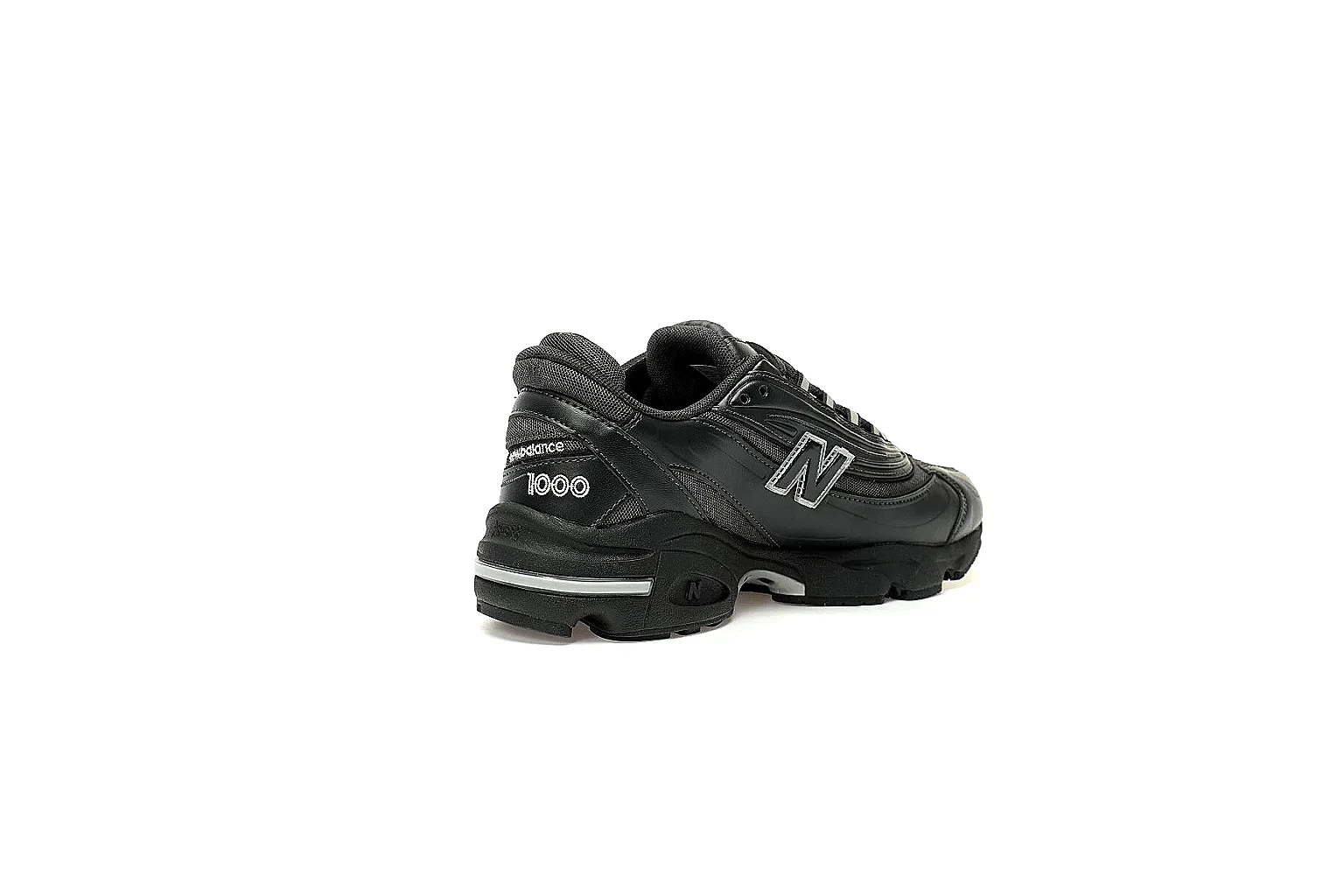 Black New Balance 1000 9807 side profile with mesh panels and silver accents