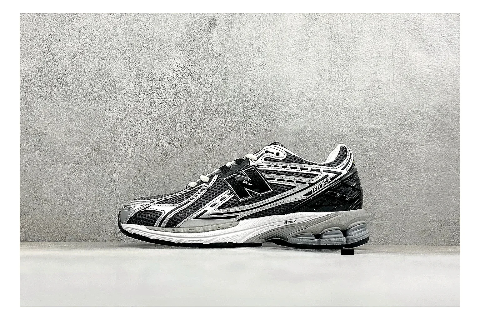 New Balance 1906 Black Silver comparison photo showing black mesh base, silver overlays, technical 1906 runner structure, and layered performance sole