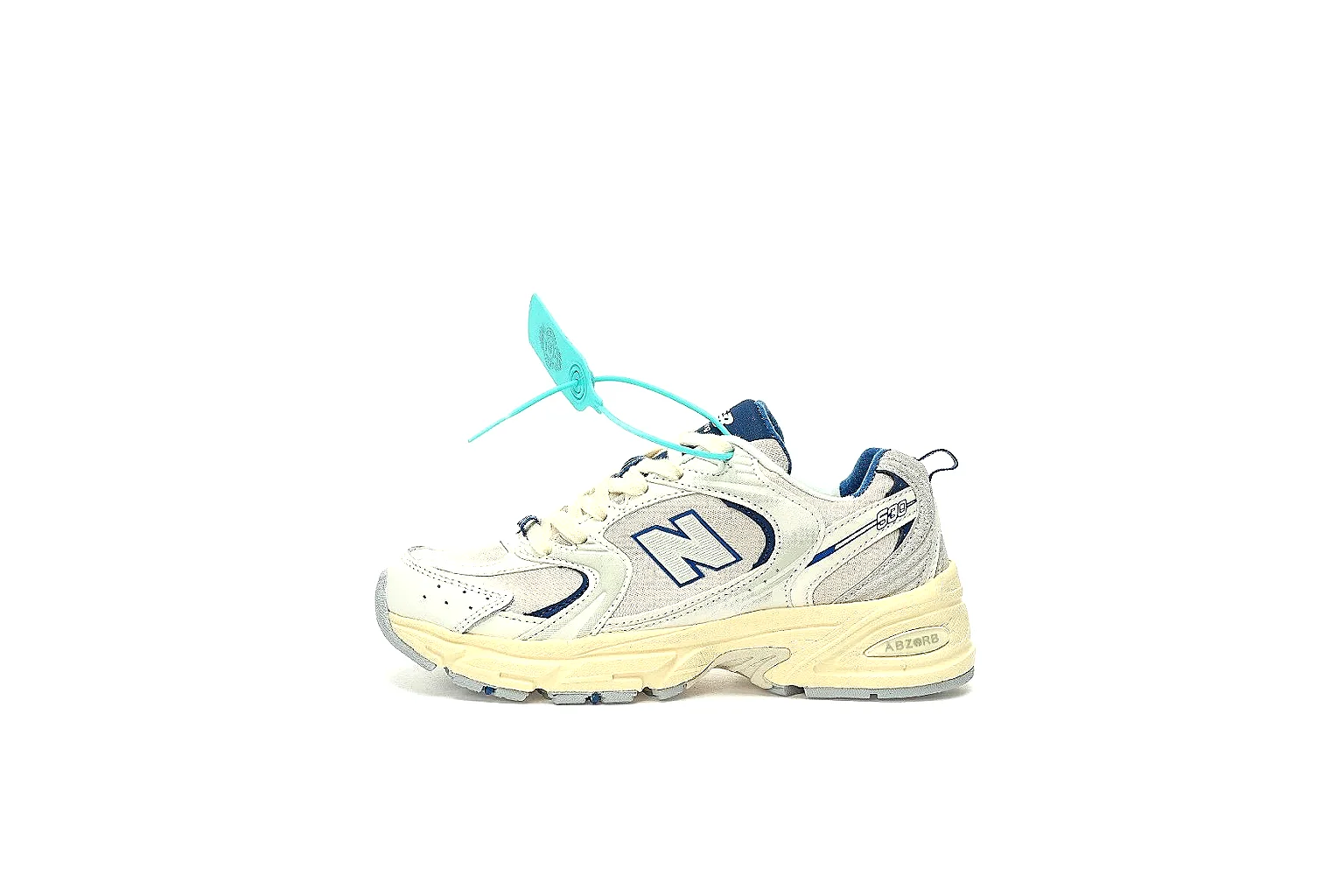 New Balance 530 cream navy side profile with navy N logo and ABZORB-style midsole
