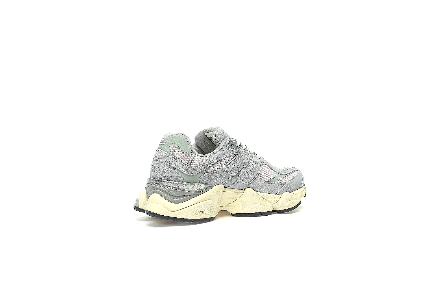 New Balance 9060 grey cream pair with visible N logo, tongue badge, and black outsole pods