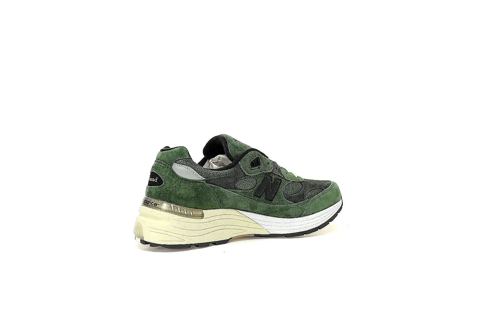 New Balance olive charcoal runner with visible side logo and cream midsole