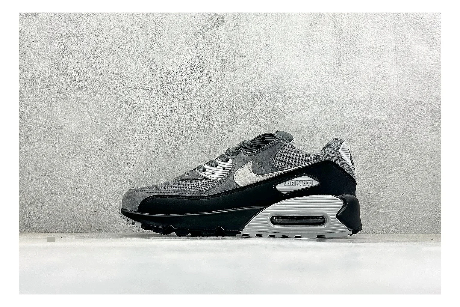 Nike Air Max 90 Grey Black comparison photo showing grey and black layered upper, visible Air window, classic Air Max 90 panels, and sturdy retro sole