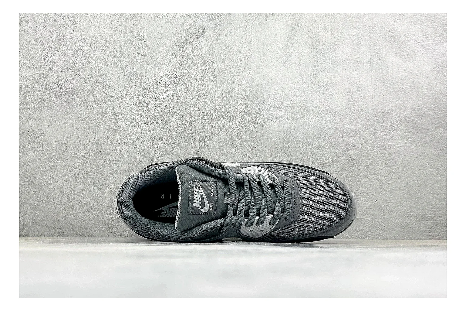 Nike Air Max 90 Grey Black comparison photo showing grey and black layered upper, visible Air window, classic Air Max 90 panels, and sturdy retro sole