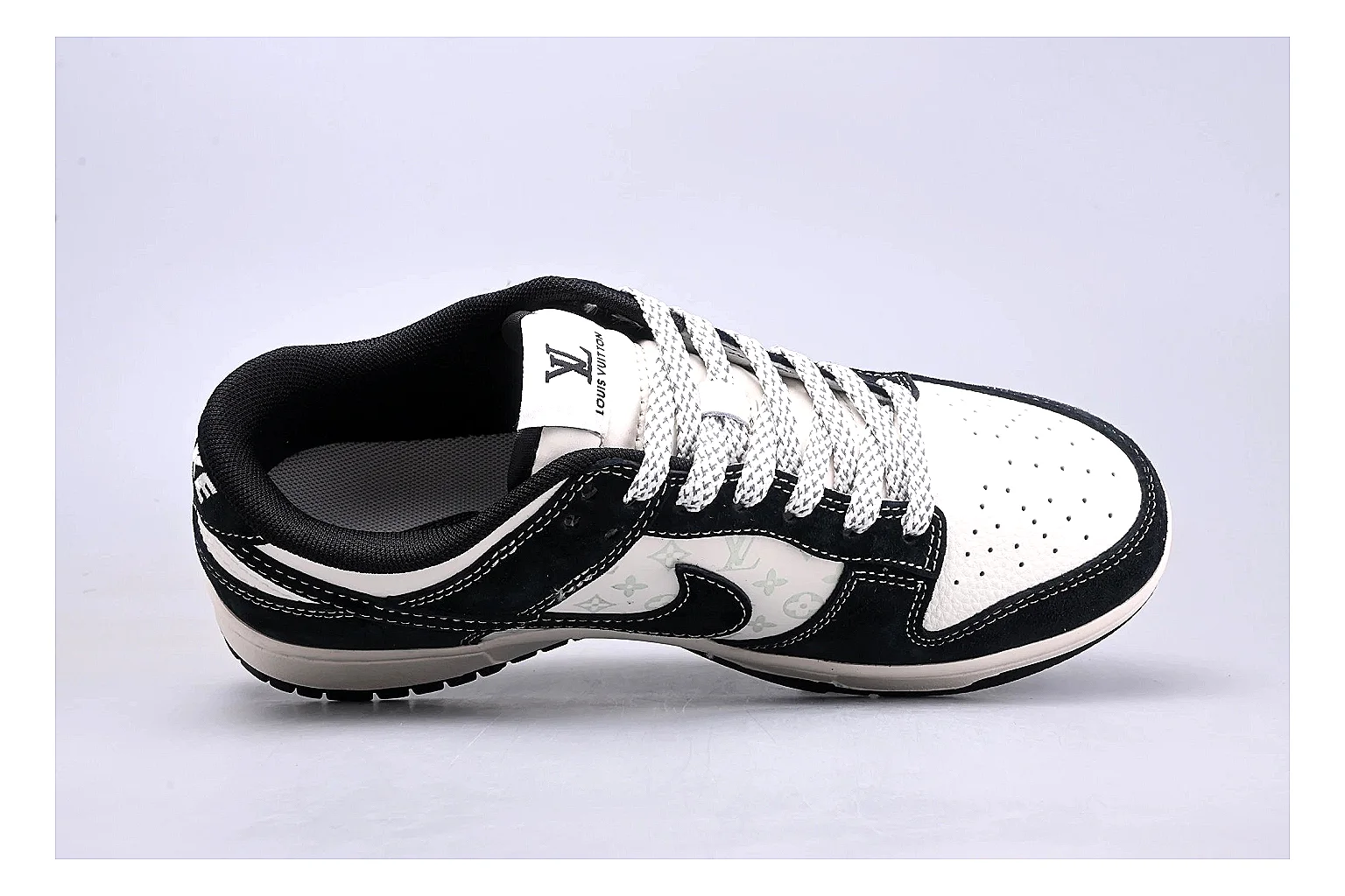 Nike Dunk Low Black White comparison photo showing black and white leather panels, low Dunk silhouette, padded collar, and basketball-retro sole