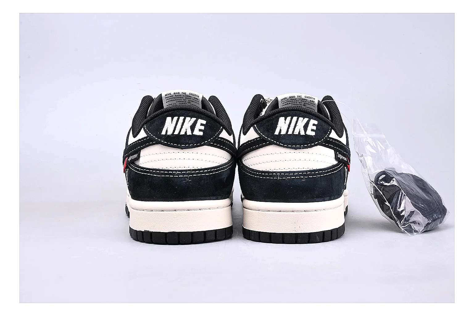 Nike Dunk Low Black White comparison photo showing black and white leather panels, low Dunk silhouette, padded collar, and basketball-retro sole thumbnail 4