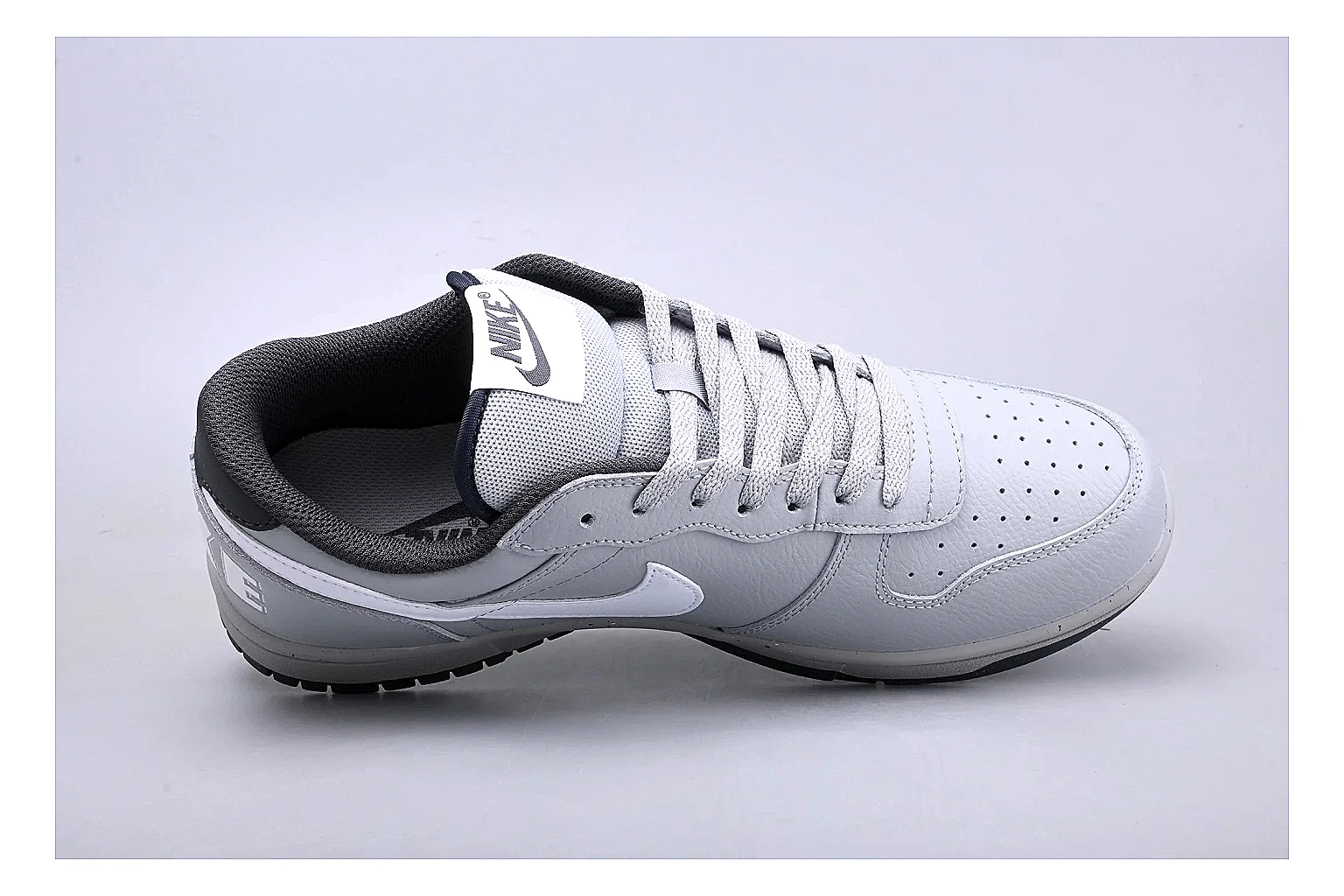 Nike Dunk Low White Gray comparison photo showing white and gray leather panels, low Dunk shape, padded collar, and basketball-retro sole thumbnail 2