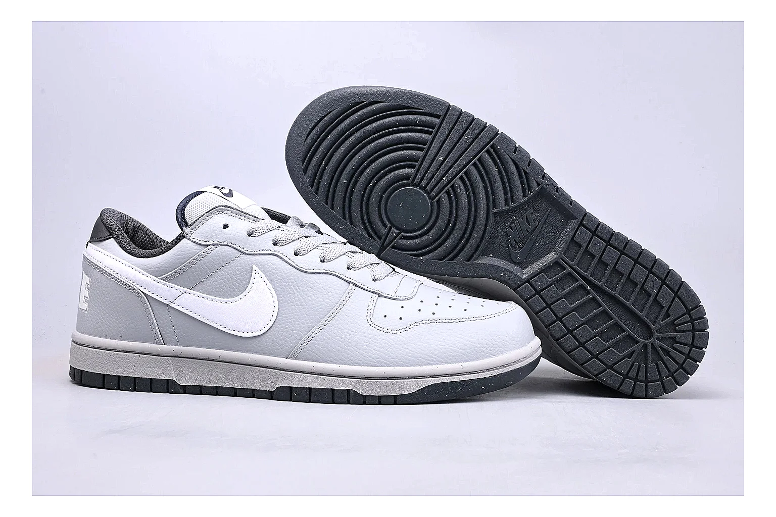 Nike Dunk Low White Gray comparison photo showing white and gray leather panels, low Dunk shape, padded collar, and basketball-retro sole thumbnail 3