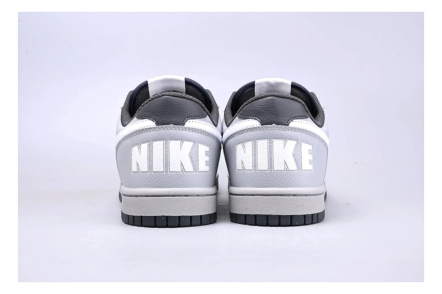 Nike Dunk Low White Gray comparison photo showing white and gray leather panels, low Dunk shape, padded collar, and basketball-retro sole thumbnail 4