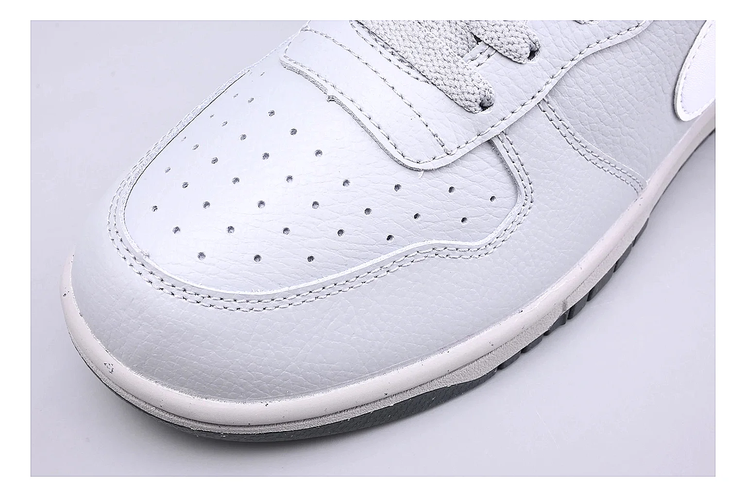 Nike Dunk Low White Gray comparison photo showing white and gray leather panels, low Dunk shape, padded collar, and basketball-retro sole thumbnail 5
