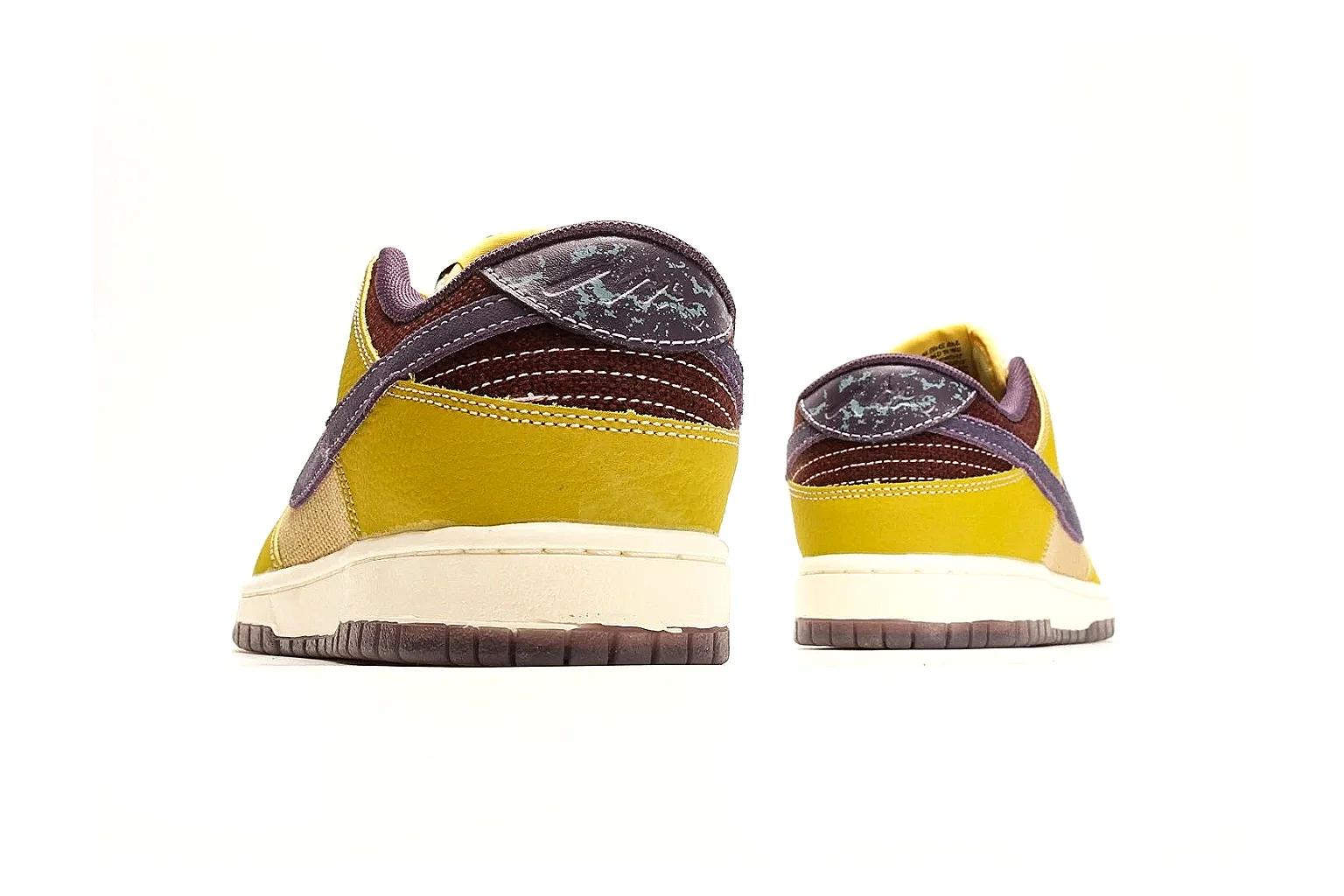 Nike Dunk Low Yellow Purple comparison photo showing yellow and purple leather panels, dark Swoosh, heel overlay, cream midsole, and brown outsole thumbnail 3