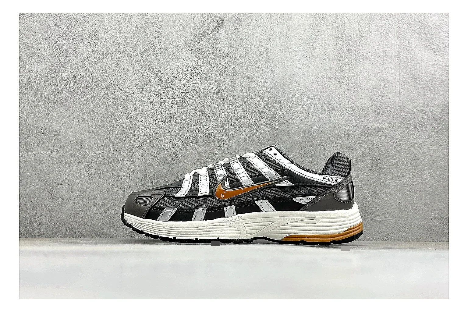 Nike P-6000 Black Orange comparison photo showing black layered runner upper, orange accent hits, retro P-6000 paneling, and cushioned casual sole