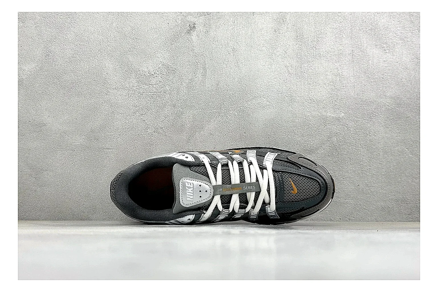 Nike P-6000 Black Orange comparison photo showing black layered runner upper, orange accent hits, retro P-6000 paneling, and cushioned casual sole