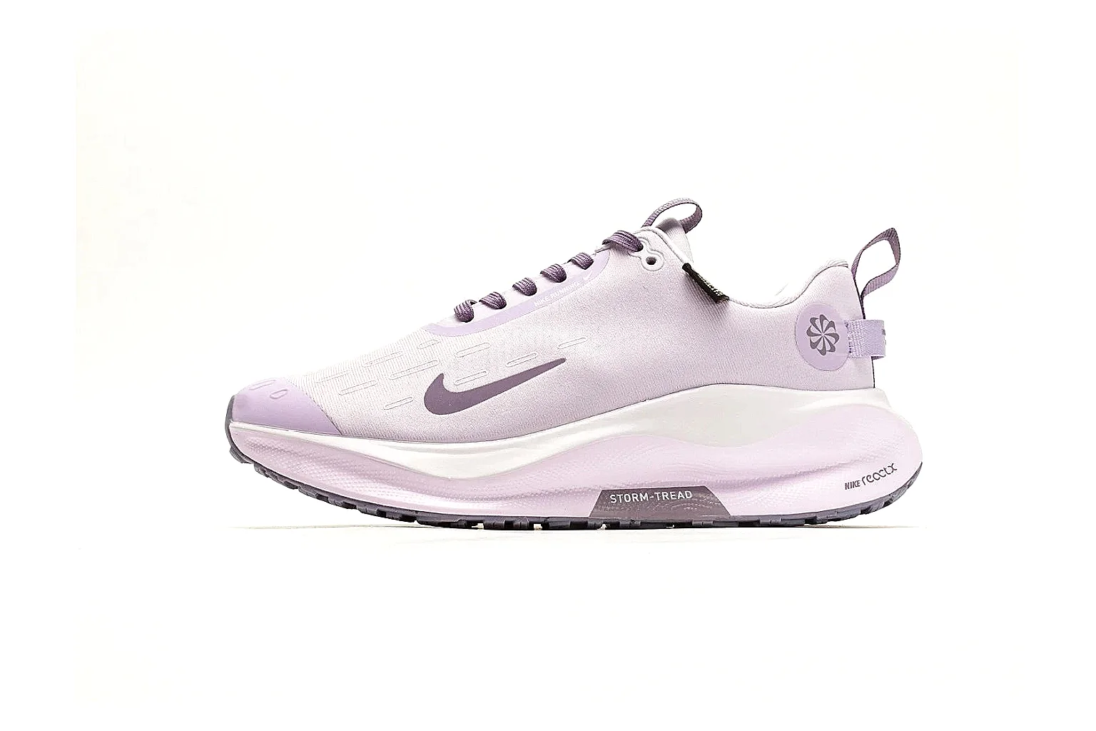 Nike ReactX GORE-TEX Lilac Sneakers comparison photo showing lilac textile upper, small Swoosh, heel pull tabs, cushioned ReactX-style sole, and weather-ready low profile