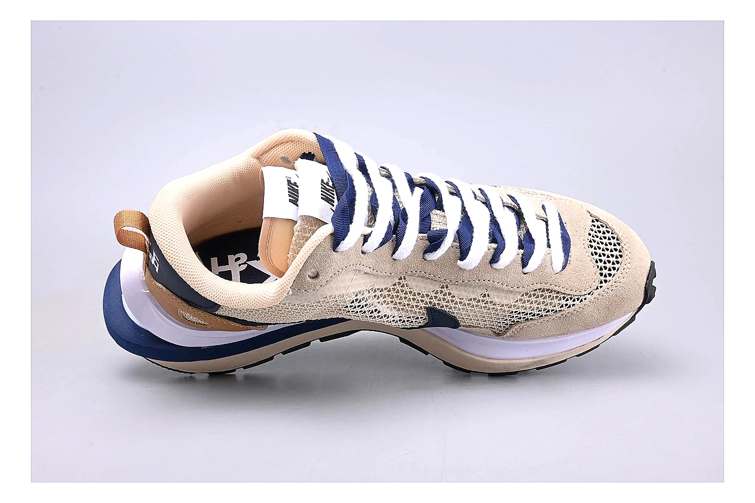 Nike Retro Runner Beige Blue comparison photo showing beige suede-mesh runner upper, blue accent panels, low retro profile, and cushioned running sole