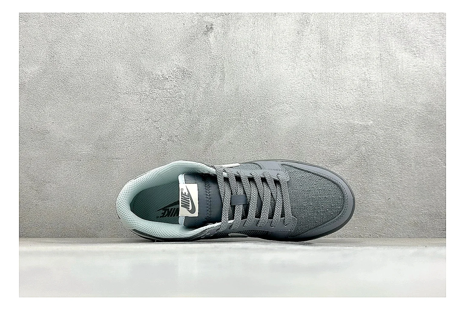 Nike SB Dunk Low Grey comparison photo showing grey low-top skate upper, white Swoosh, padded collar, and classic Dunk sole thumbnail 2