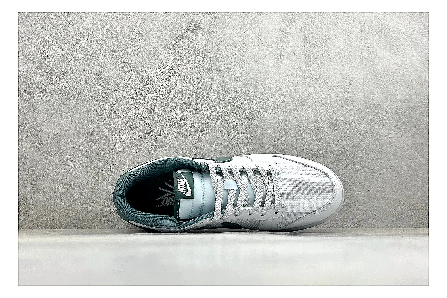 Nike SB Dunk Low White Green comparison photo showing white low-top skate upper, green Swoosh, padded collar, and classic Dunk sole shape