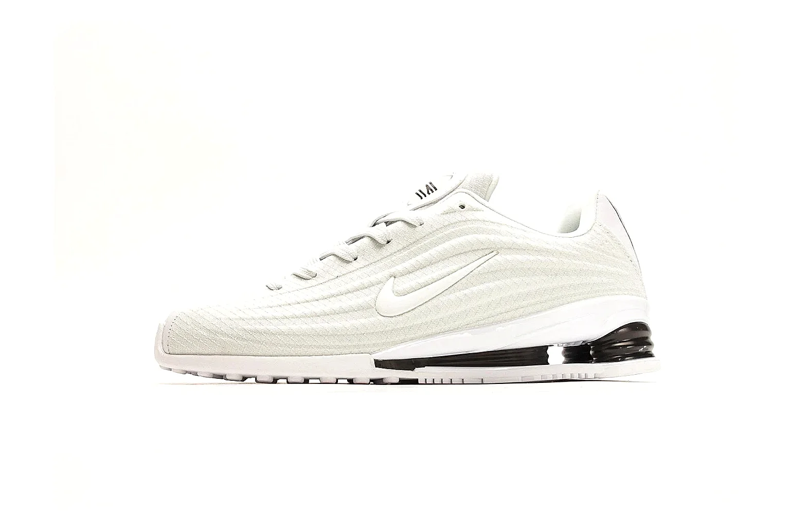 Nike Shox Z White Sneakers comparison photo showing white streamlined layered upper, small Swoosh, black heel cushioning columns, and modern low runner shape