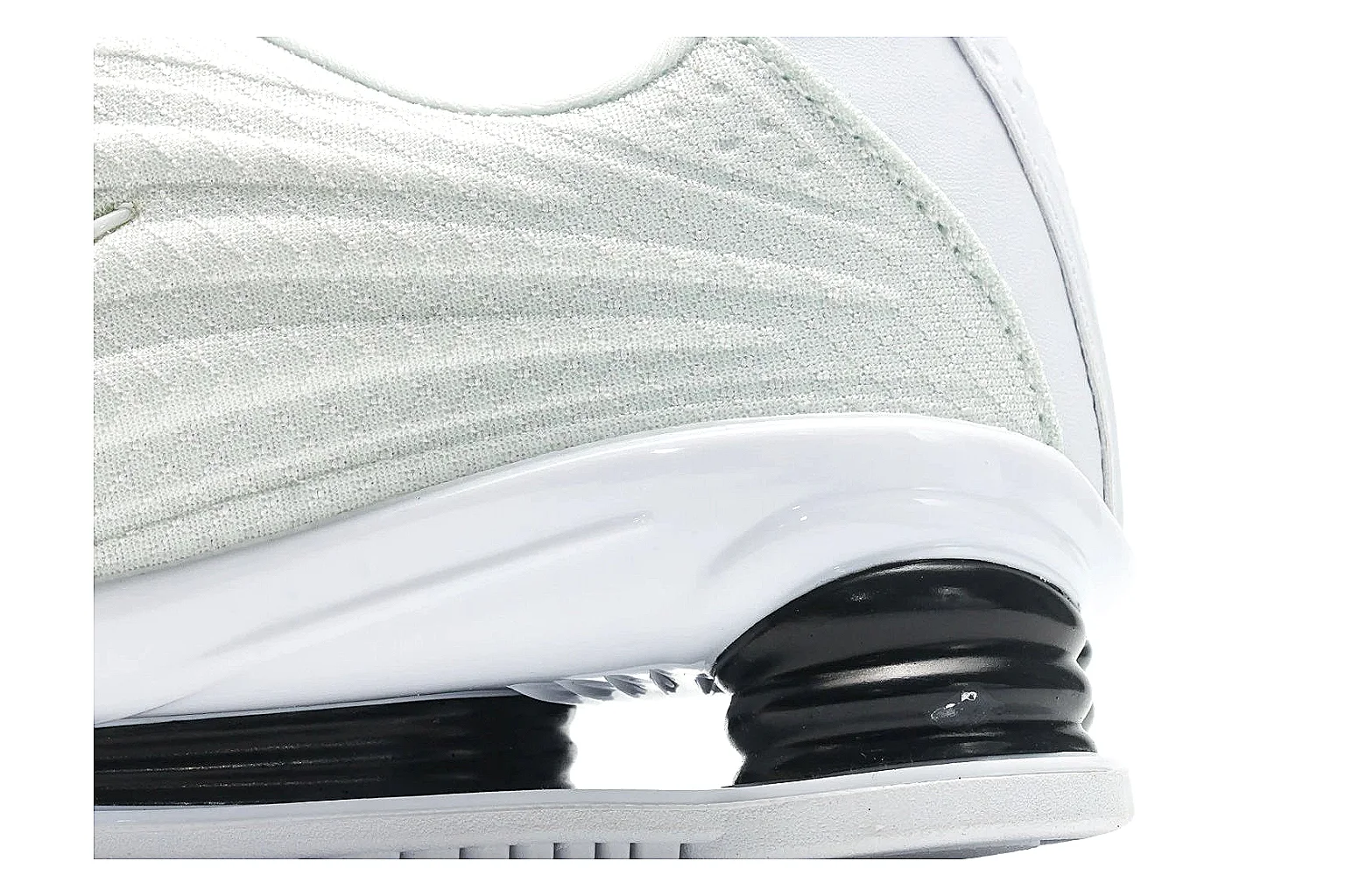 Nike Shox Z White Sneakers comparison photo showing white streamlined layered upper, small Swoosh, black heel cushioning columns, and modern low runner shape thumbnail 5