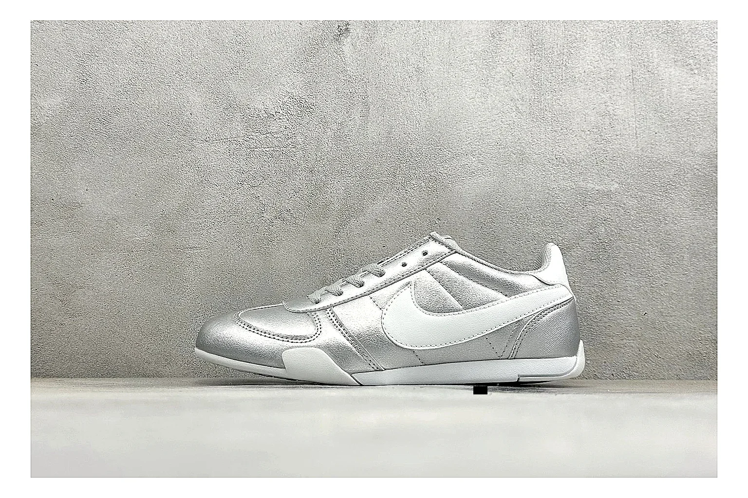 Nike Sprint Sister Silver comparison photo showing silver retro-runner upper, slim low-top shape, layered side panels, and a light everyday sole