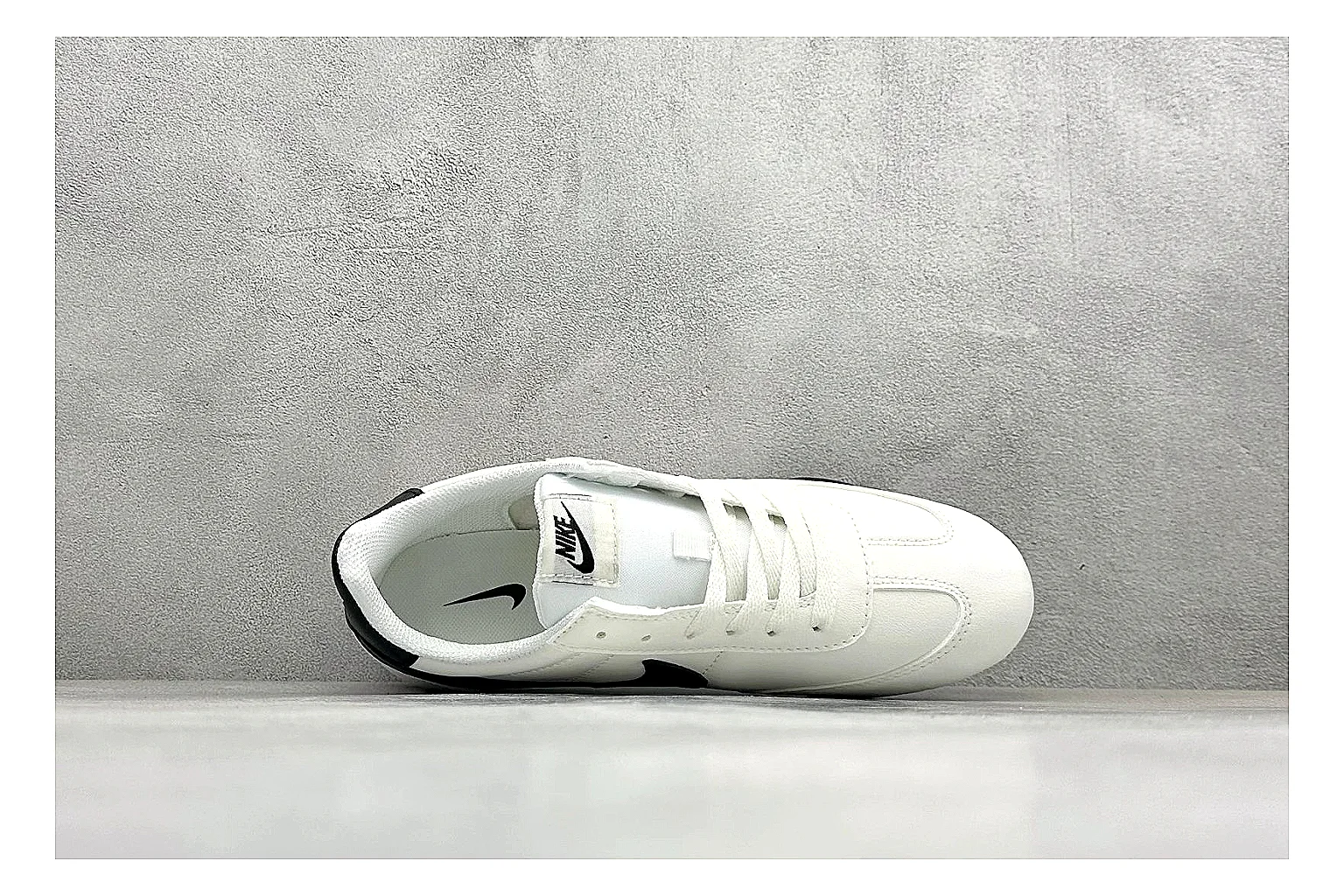 Nike Sprint Sister White Black comparison photo showing white retro-runner upper, black Swoosh contrast, slim low-top profile, and light casual sole