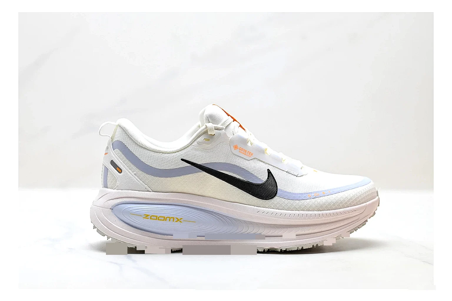 Nike Vomero White Orange comparison photo showing white mesh runner upper, orange accents, layered Vomero-style panels, and cushioned modern sole