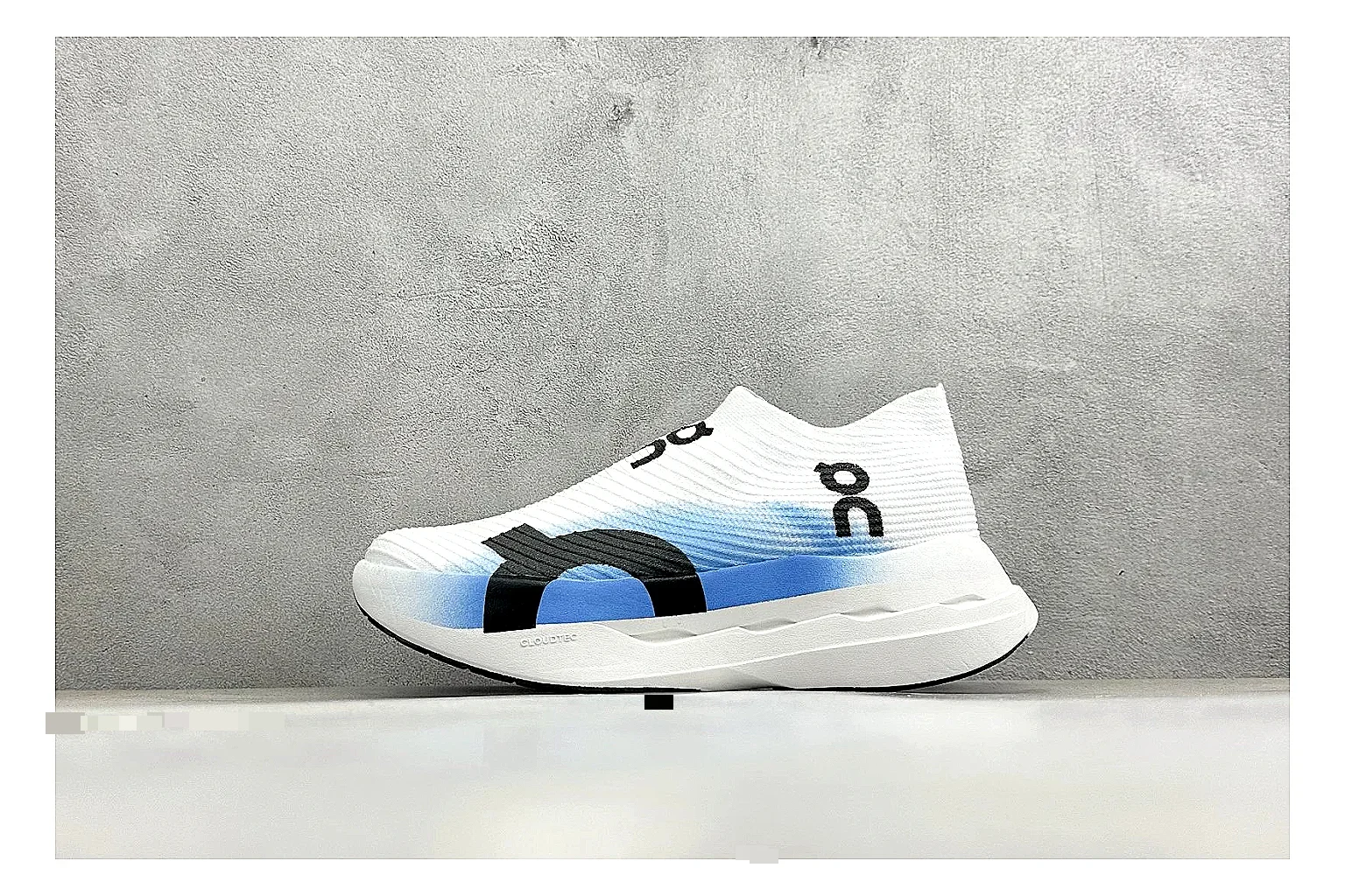 On Cloudboom White Blue comparison photo showing white performance mesh, blue gradient accents, slim racing profile, and segmented CloudTec sole