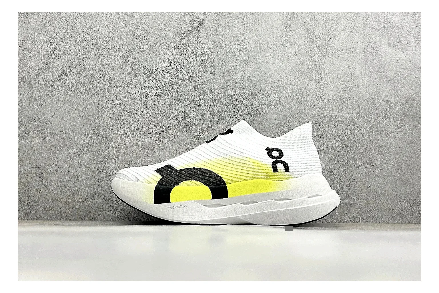 On Cloudboom White Lime comparison photo showing white performance mesh, lime gradient accents, slim racing profile, and segmented CloudTec sole