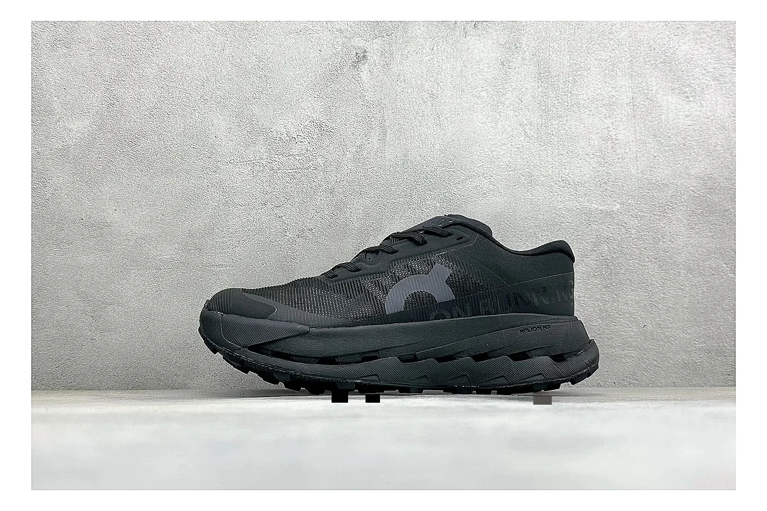On Cloudmonster Triple Black comparison photo showing triple black mesh upper, oversized CloudTec sole pods, tonal laces, and rounded runner shape
