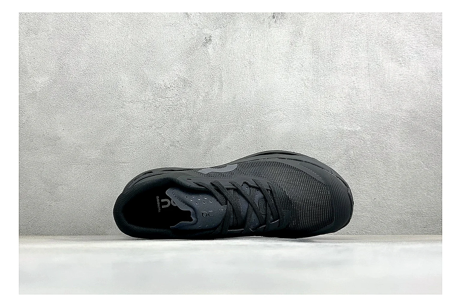 On Cloudmonster Triple Black comparison photo showing triple black mesh upper, oversized CloudTec sole pods, tonal laces, and rounded runner shape thumbnail 2