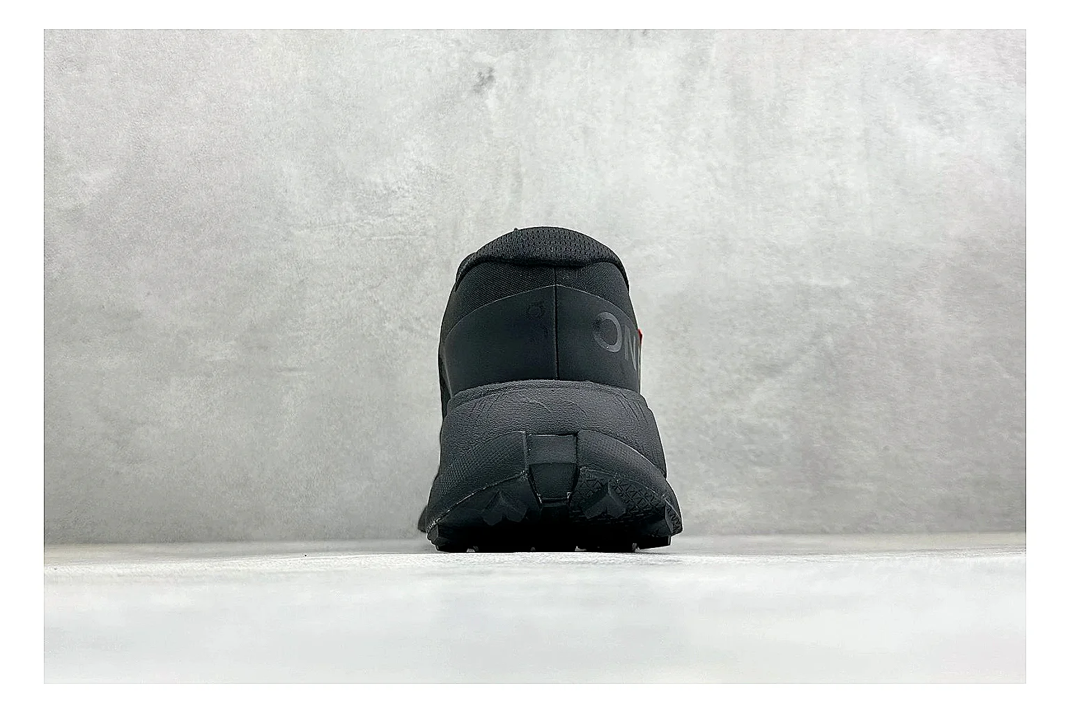 On Cloudmonster Triple Black comparison photo showing triple black mesh upper, oversized CloudTec sole pods, tonal laces, and rounded runner shape thumbnail 3
