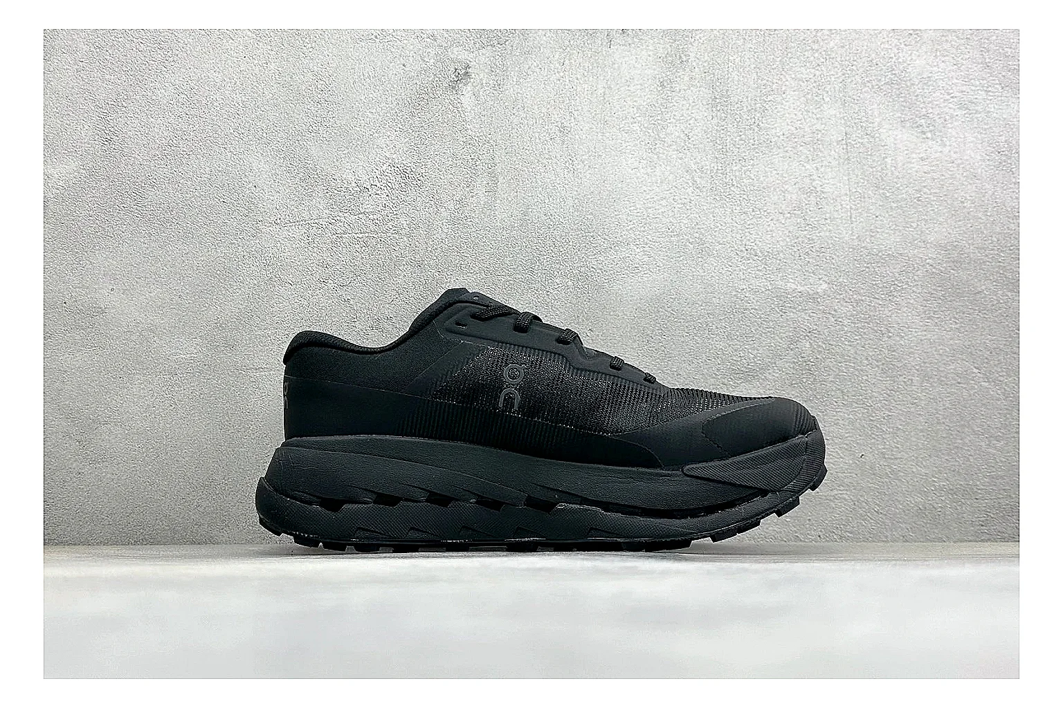 On Cloudmonster Triple Black comparison photo showing triple black mesh upper, oversized CloudTec sole pods, tonal laces, and rounded runner shape thumbnail 6