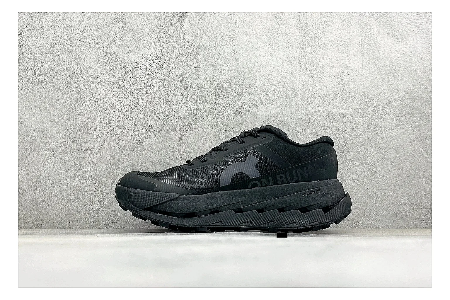 On Cloudmonster Triple Black comparison photo showing triple black running upper, oversized CloudTec pod sole, tonal laces, and rounded performance shape