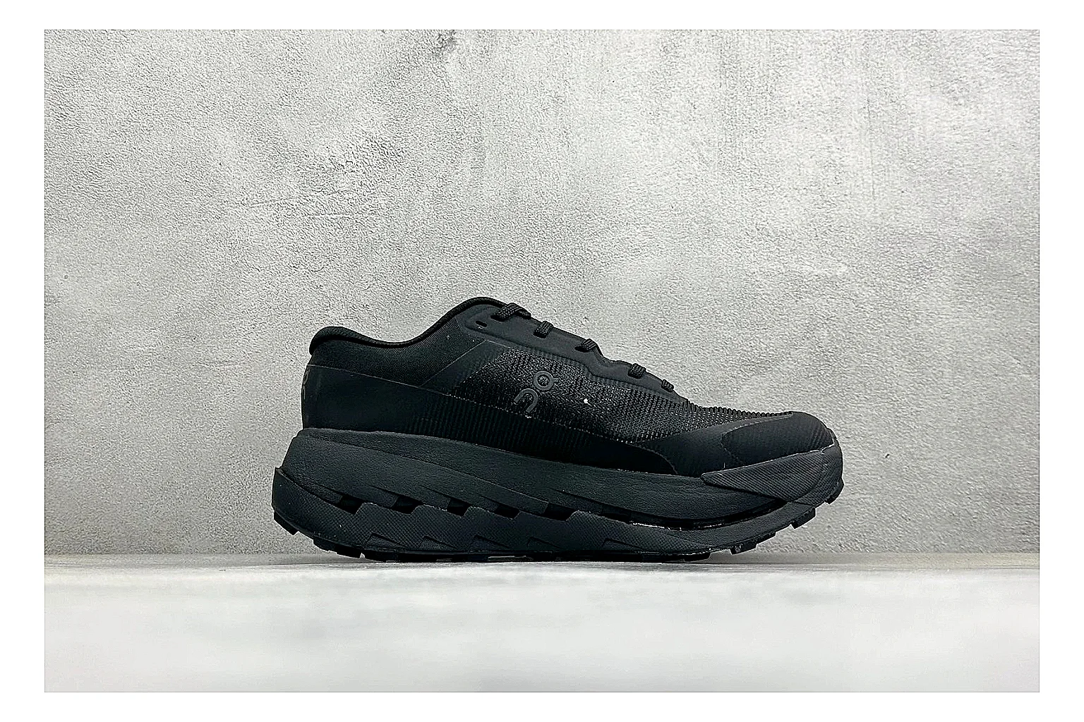 On Cloudmonster Triple Black comparison photo showing triple black running upper, oversized CloudTec pod sole, tonal laces, and rounded performance shape thumbnail 6