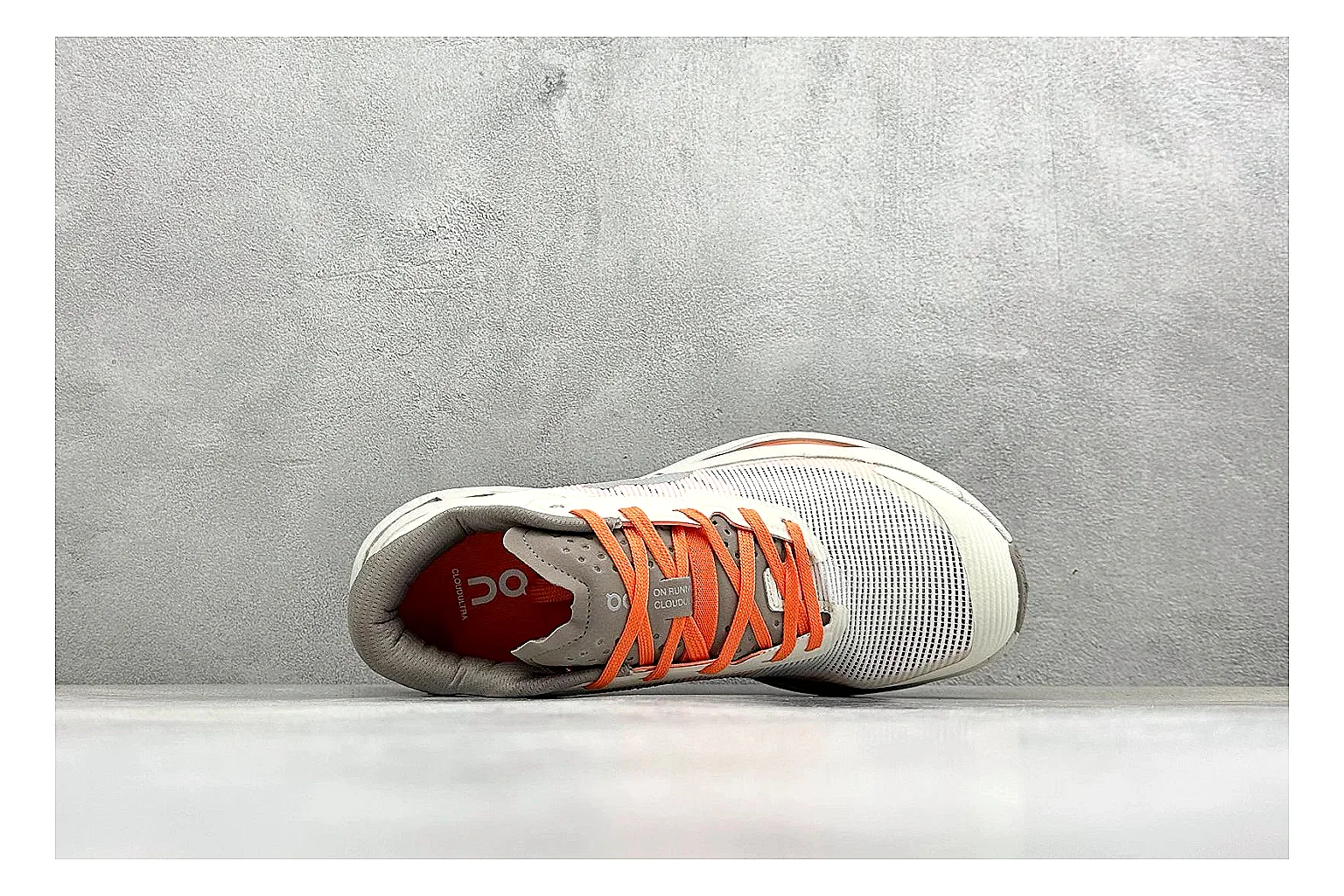 On Cloudmonster White Orange comparison photo showing white running mesh, orange accent hits, oversized CloudTec sole pods, and a rounded runner silhouette thumbnail 2