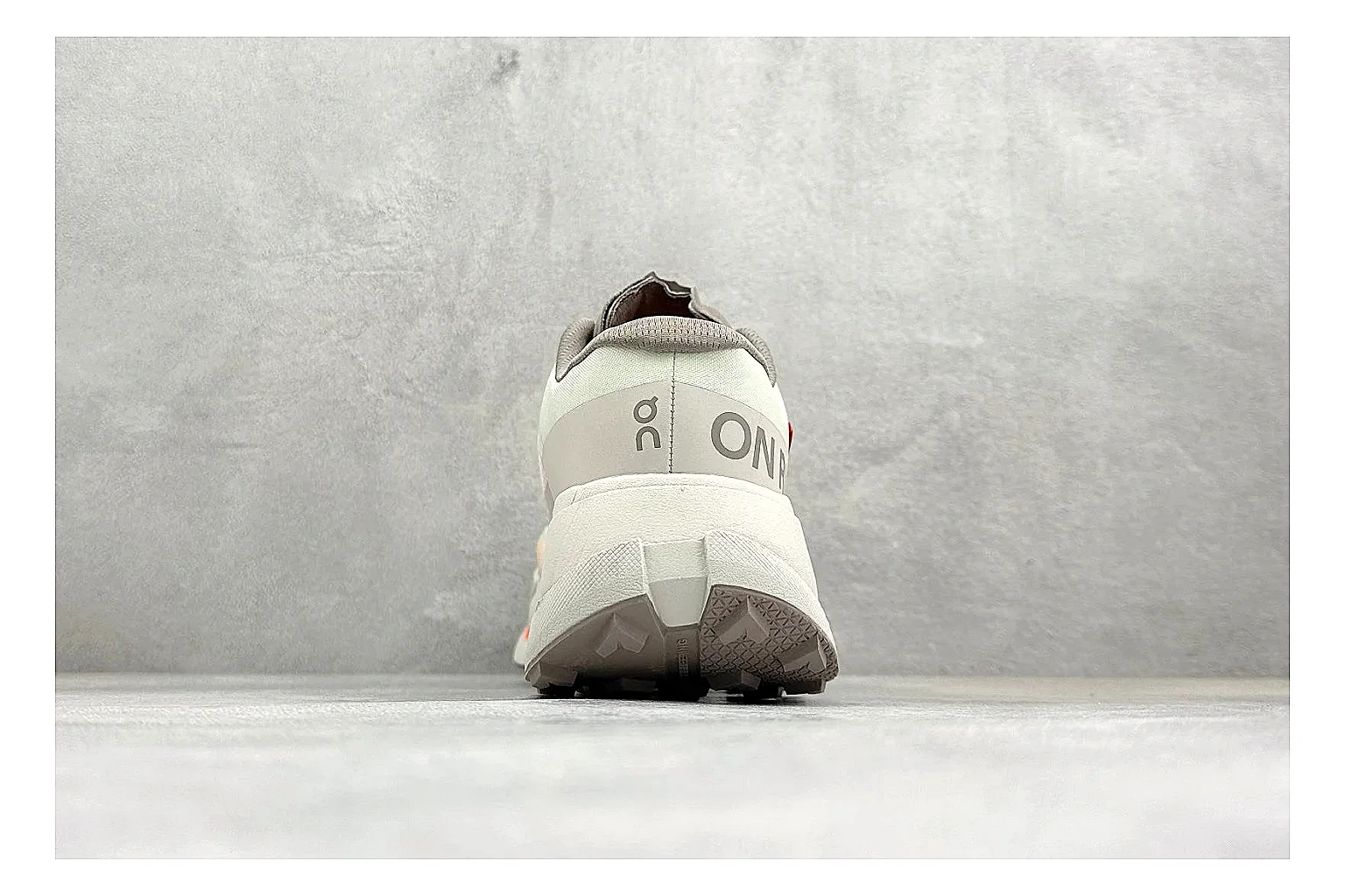 On Cloudmonster White Orange comparison photo showing white running mesh, orange accent hits, oversized CloudTec sole pods, and a rounded runner silhouette thumbnail 3