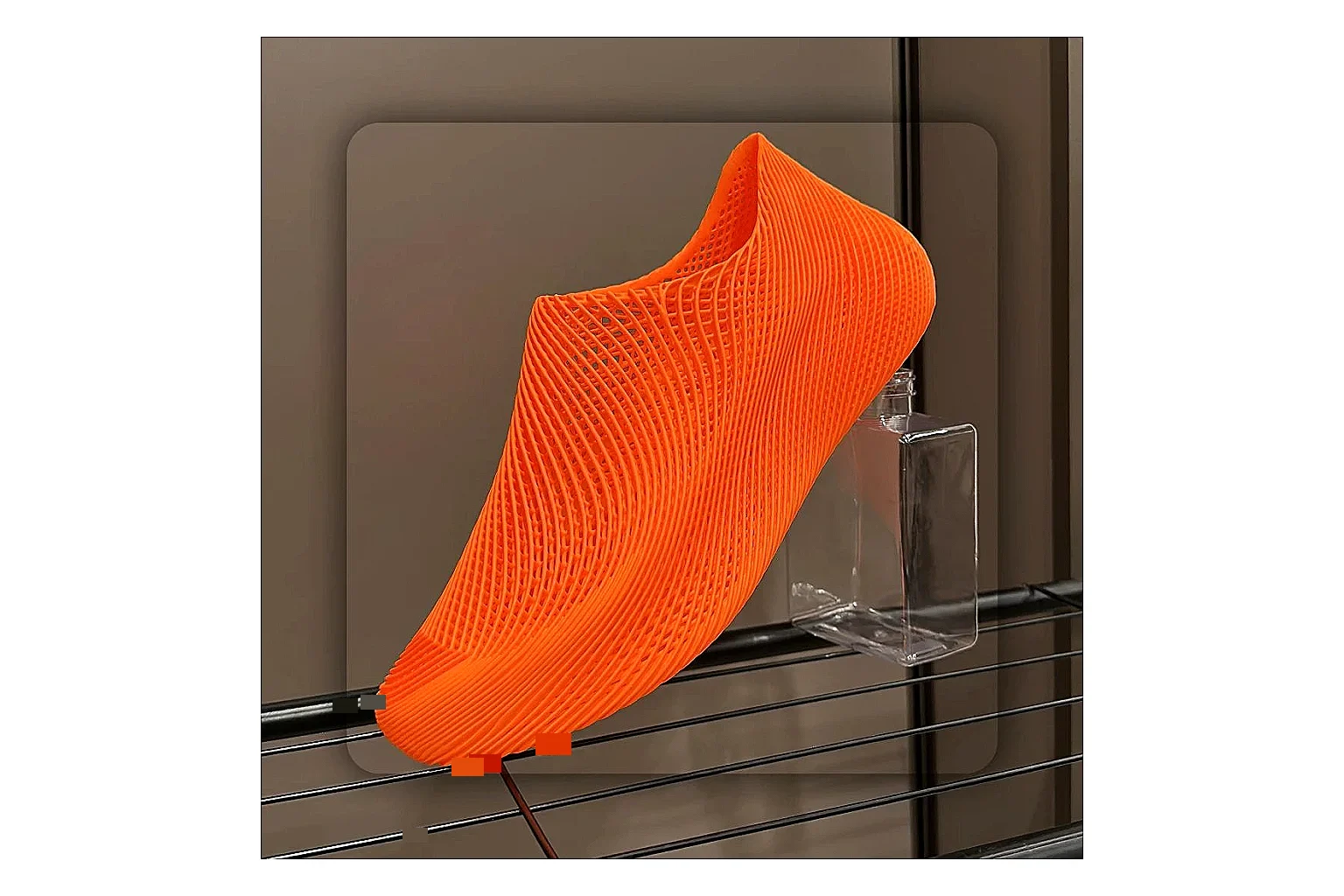 Other 4D Printed Orange Slip-On Sneakers comparison photo showing orange open-grid upper, seamless slip-on shape, sculpted sole, and futuristic lightweight profile