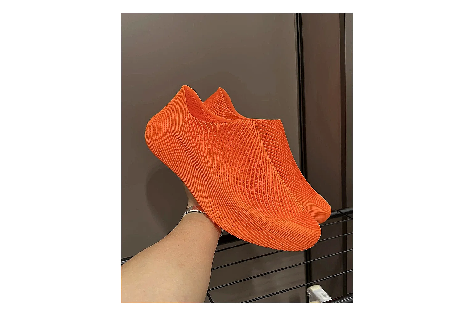 Other 4D Printed Orange Slip-On Sneakers comparison photo showing orange open-grid upper, seamless slip-on shape, sculpted sole, and futuristic lightweight profile thumbnail 2
