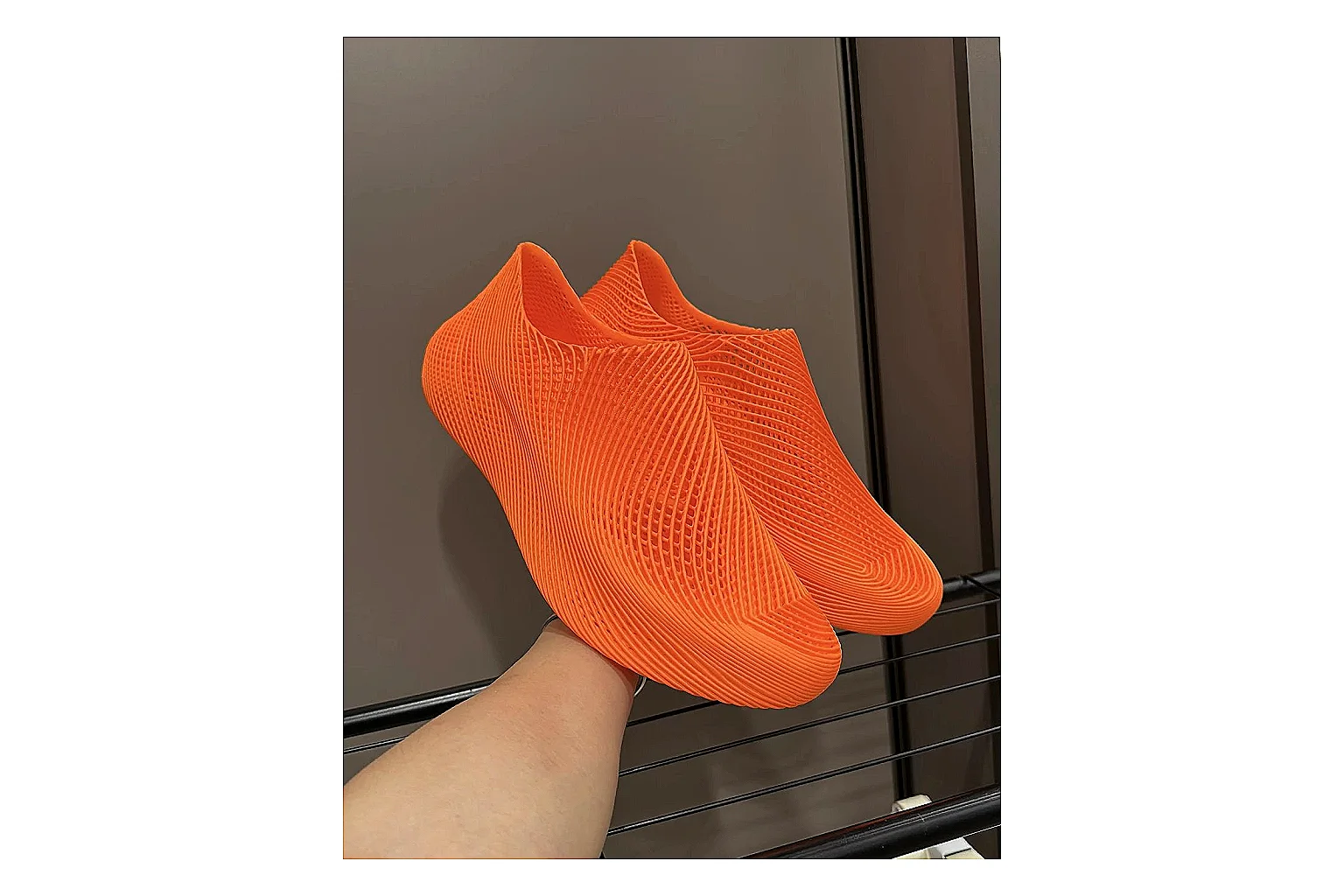 Other 4D Printed Orange Slip-On Sneakers comparison photo showing orange open-grid upper, seamless slip-on shape, sculpted sole, and futuristic lightweight profile thumbnail 3