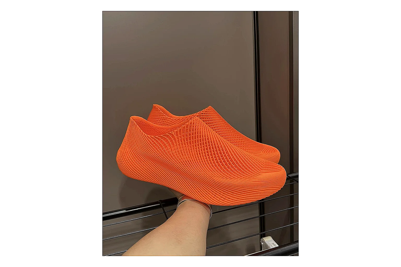 Other 4D Printed Orange Slip-On Sneakers comparison photo showing orange open-grid upper, seamless slip-on shape, sculpted sole, and futuristic lightweight profile thumbnail 6