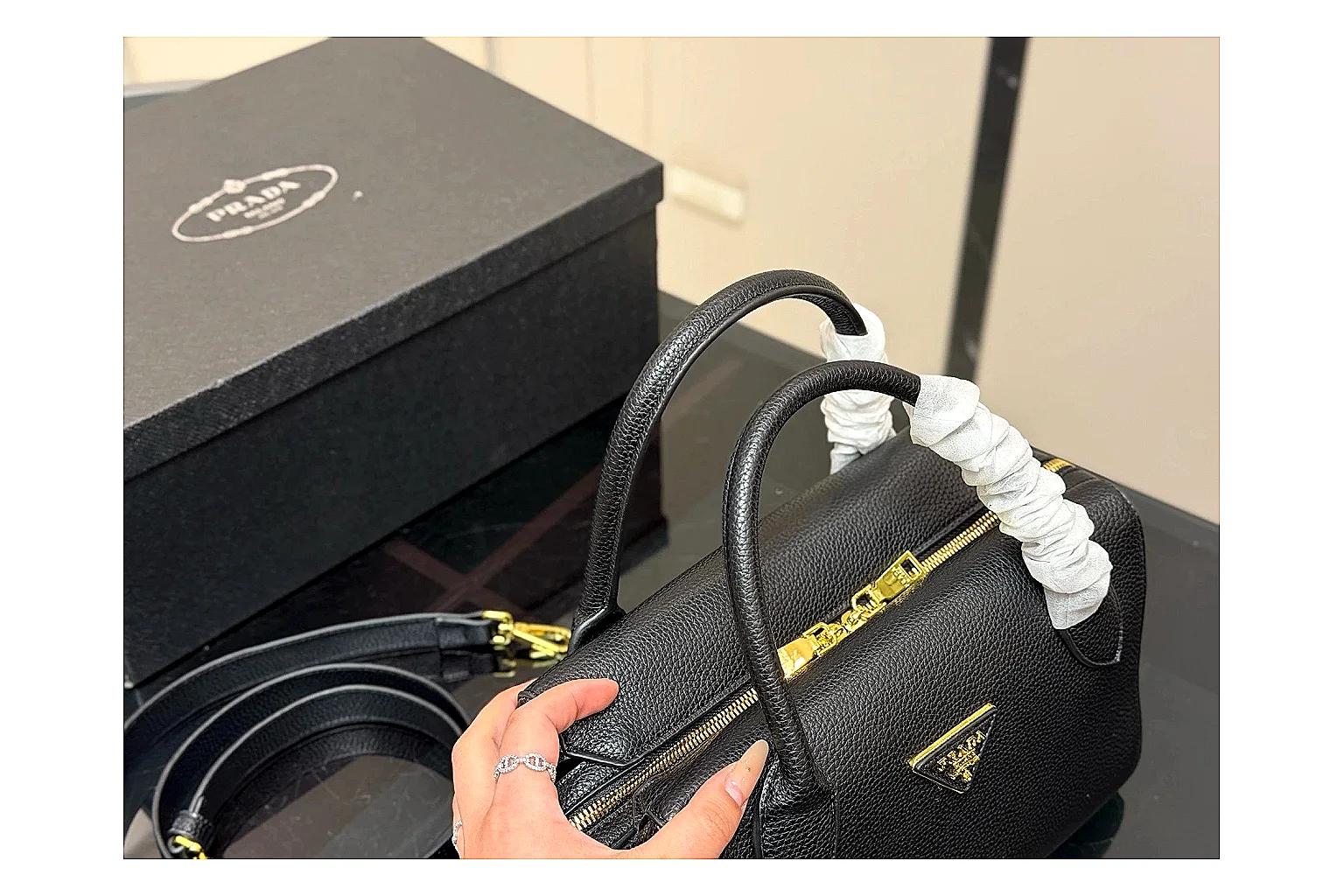 Prada Mini Top Handle Black comparison photo showing black leather mini bag body, structured top handle, compact silhouette, and clean metal hardware thumbnail 2