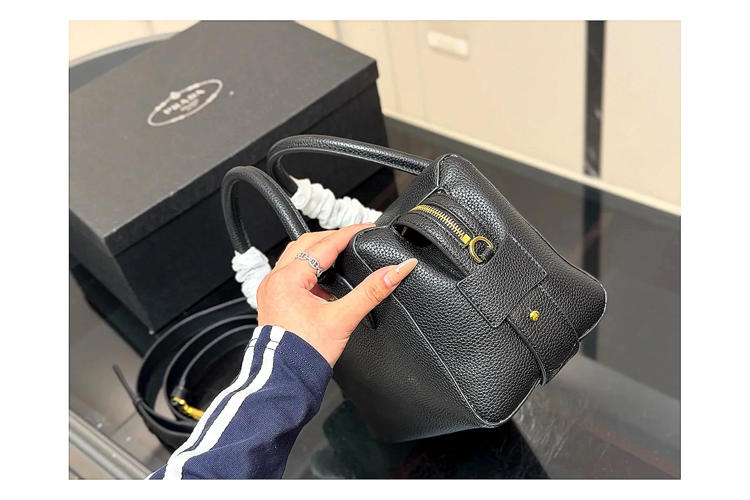 Prada Mini Top Handle Black comparison photo showing black leather mini bag body, structured top handle, compact silhouette, and clean metal hardware thumbnail 5