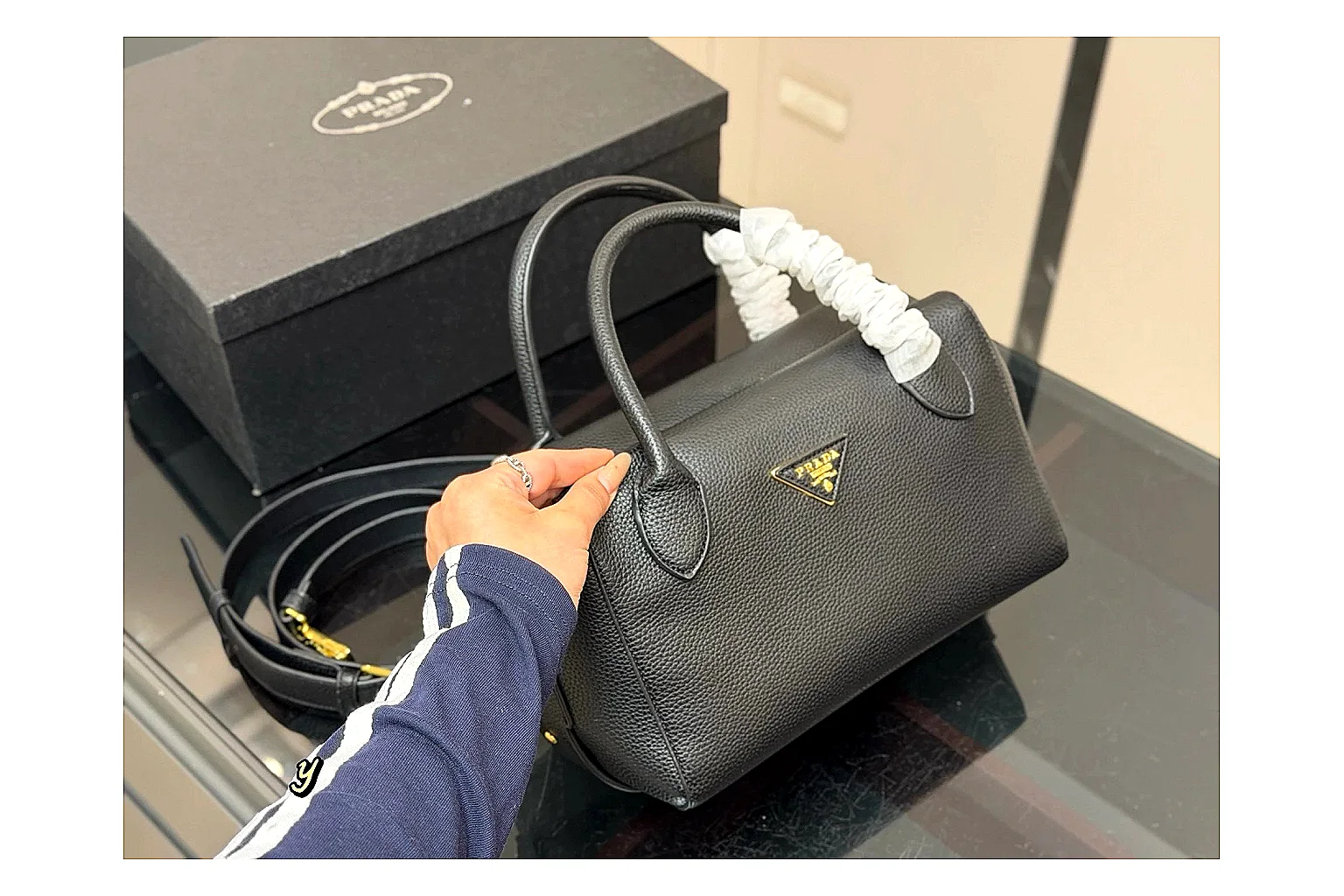Prada Mini Top Handle Black comparison photo showing black leather mini bag body, structured top handle, compact silhouette, and clean metal hardware thumbnail 6