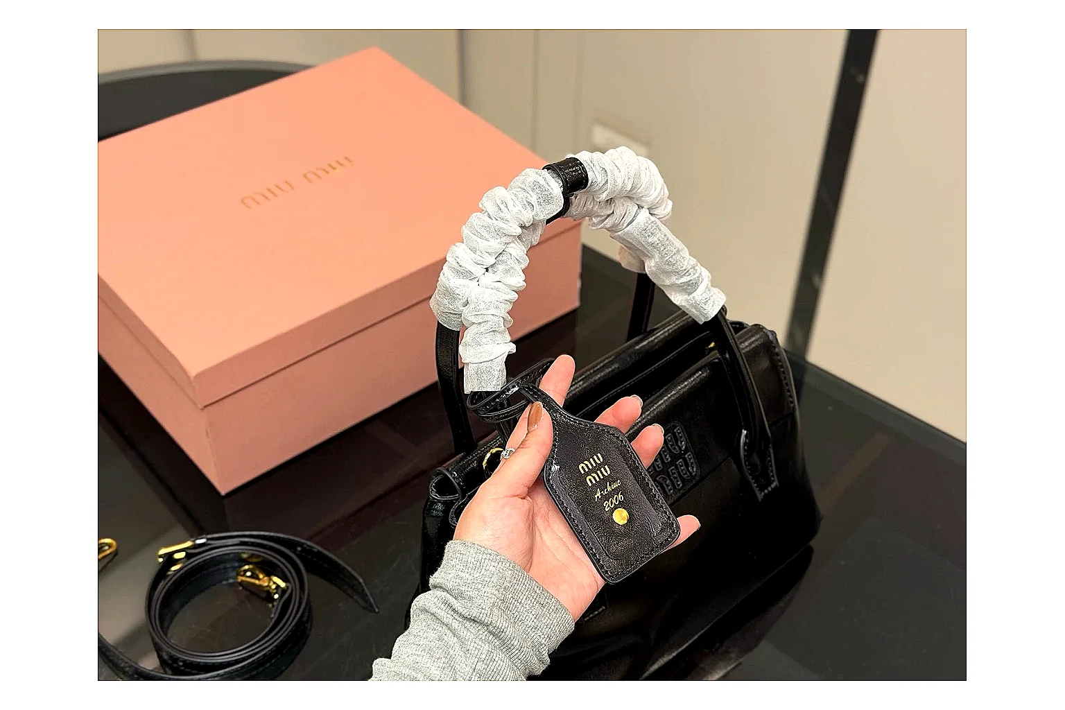 Prada Mini Top Handle Black comparison photo showing black leather mini bag body, structured top handle, compact luxury shape, and clean hardware details thumbnail 2
