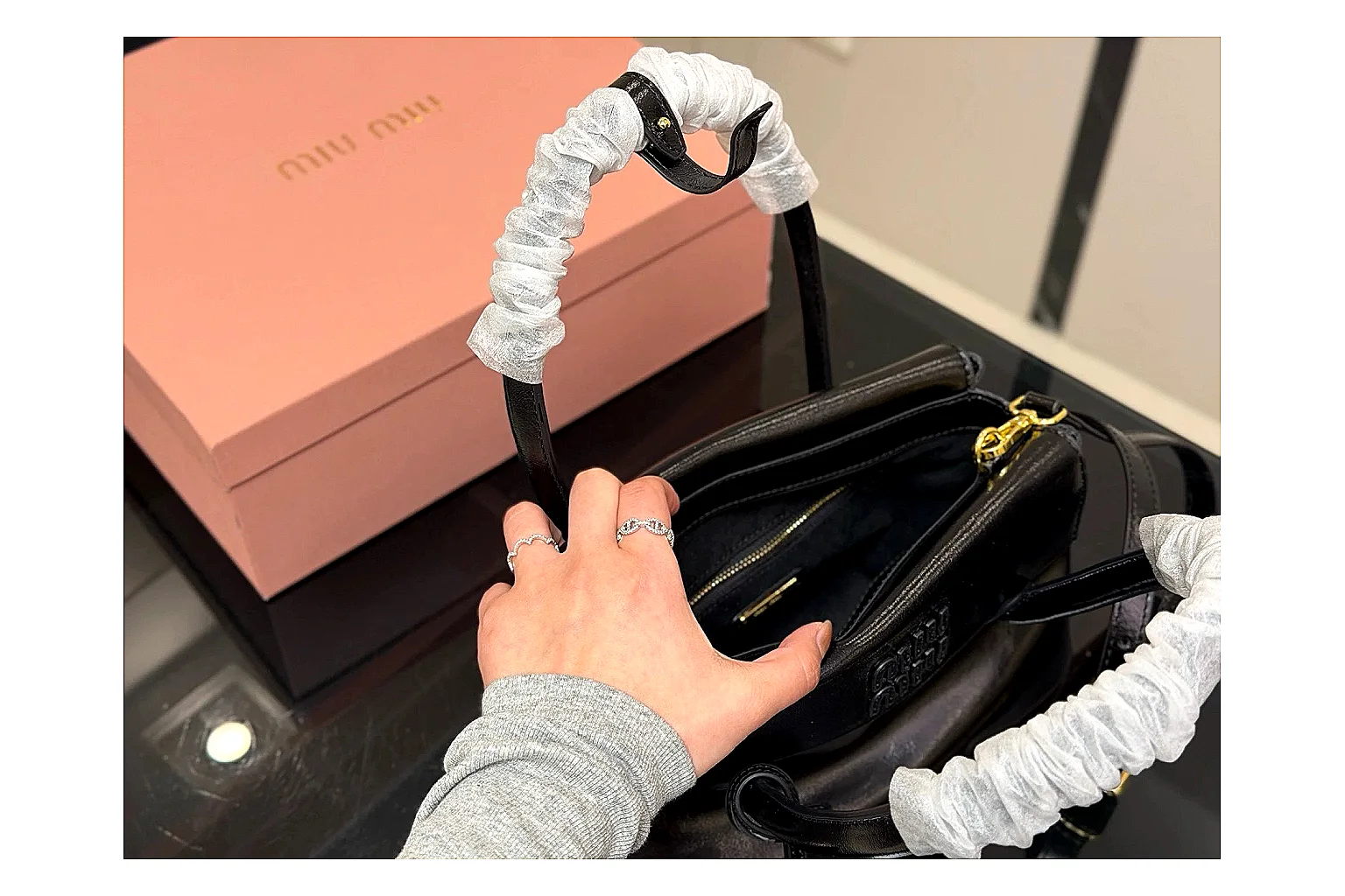 Prada Mini Top Handle Black comparison photo showing black leather mini bag body, structured top handle, compact luxury shape, and clean hardware details thumbnail 4