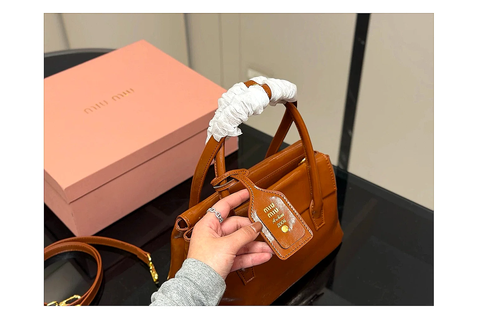 Prada Mini Top Handle Orange Brown comparison photo showing orange brown leather mini bag body, structured top handle, compact shape, and clean hardware details thumbnail 2